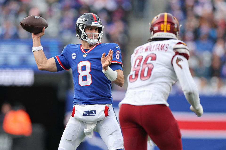 Dec 4, 2022; East Rutherford, New Jersey, USA; New York Giants quarterback Daniel Jones (8) throws the ball as Washington Commanders defensive end James Smith-Williams (96) pursues during the second half at MetLife Stadium. Mandatory Credit: Vincent Carchietta-USA TODAY Sports