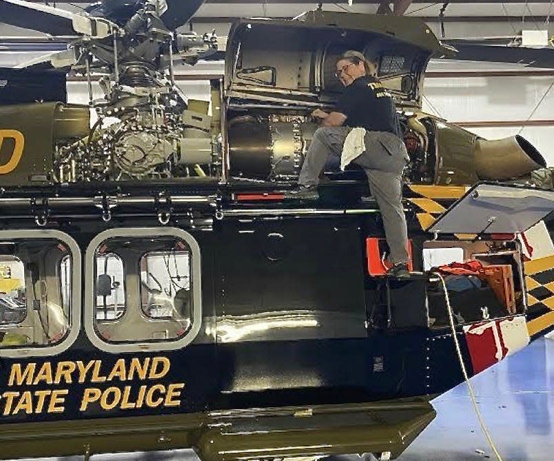 Michelle Beatty working on one of the helicopters used by the Maryland State Police. Beatty is the only female helicopter technician with the state police.