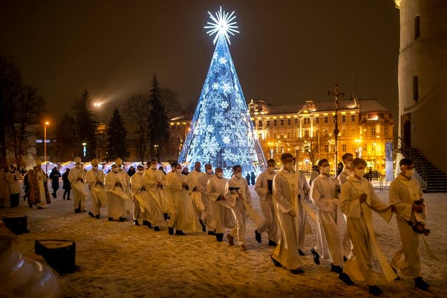 Priests and clergy walk in a procession to attend the Christmas celebration midnight Mass at the Cathedral-Basilical in Vilnius, Lithuania (Mindaugas Kulbis/AP)