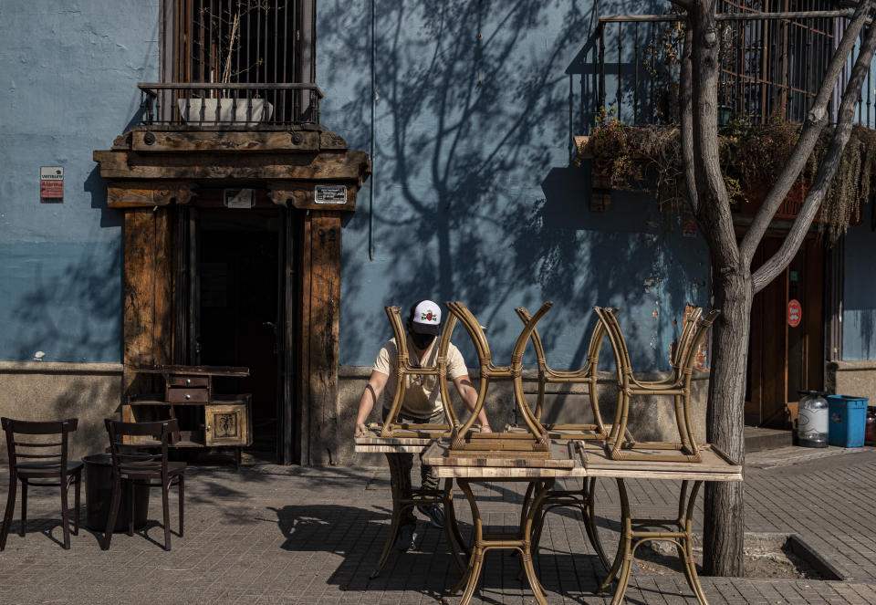 Un mesero empieza a acomodar mesas durante la reapertura de un restaurante en Santiago, Chile, el miércoles 2 de septiembre de 2020. (AP Foto/Esteban Felix)