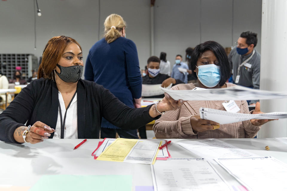 Gwinnett county workers begin their recount of the ballots on Nov. 13, 2020 in Lawrenceville, Georgia.