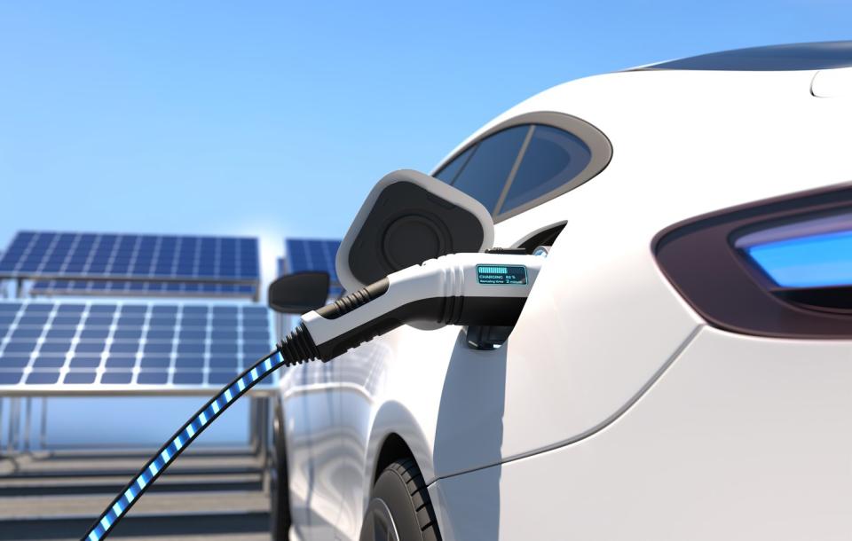 An electric vehicle plugged in at a charging station.