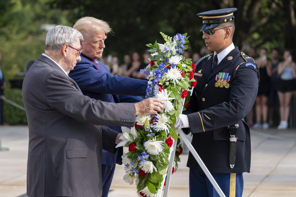 Bill Barnett, left, grandfather of Darin Taylor Hoover, and Republican presidential nominee former President Donald Trump place a wreath at the Tomb of the Unknown Solider in honor of Staff Sgt. Darin Taylor Hoover at Arlington National Cemetery, Monday, Aug. 26, 2024, in Arlington, Va. (AP Photo/Alex Brandon)