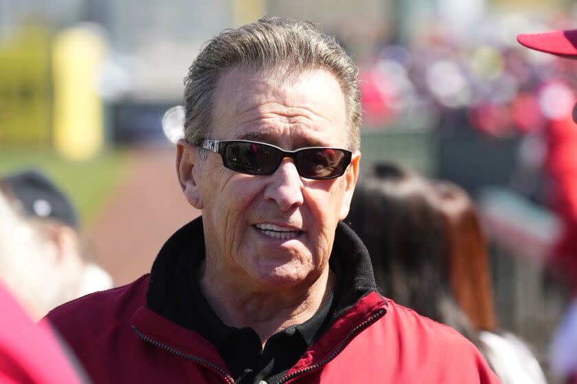 Los Angeles Angels owner Arte Moreno pauses on the field prior to a spring training baseball game.