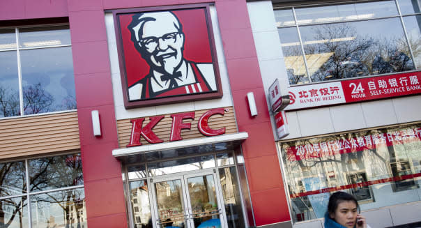 A pedestrian walks past a Yum Brands Inc. KFC restaurant in