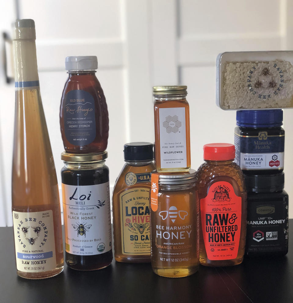 This February 24, 2020 photo taken in New York, shows some of the many brands and types of honey available today. Honey isn't just honey anymore. At farmers markets, grocery stores and restaurants, there's a wide assortment of honeys with various colors and tastes. (Katie Workman via AP)