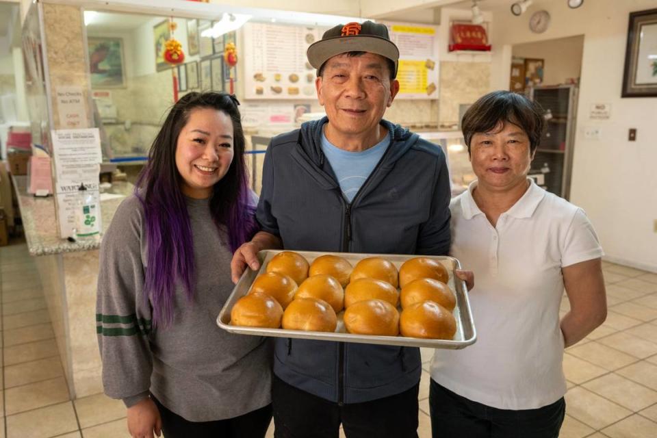 Anna Lee stands with her parents, Yao and Jenny Li, earlier this month at Lam Kwong Deli & Market, which serves dim sum and other items.