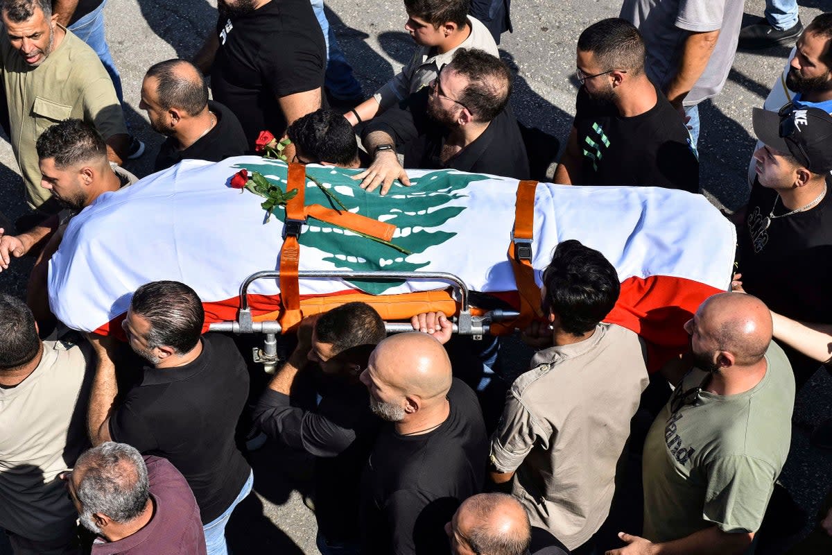 Mourners carry the flag-draped casket of Lebanese Reuters video journalist Issam Abdallah (AFP via Getty Images)