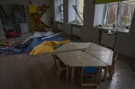 Damages seen in the classroom of a kindergarten in the aftermath of Russian missile strikes fired toward Kyiv early Sunday, where a crater pocked the courtyard, in Kyiv, Ukraine, Monday, June 27, 2022. (AP Photo/Nariman El-Mofty)