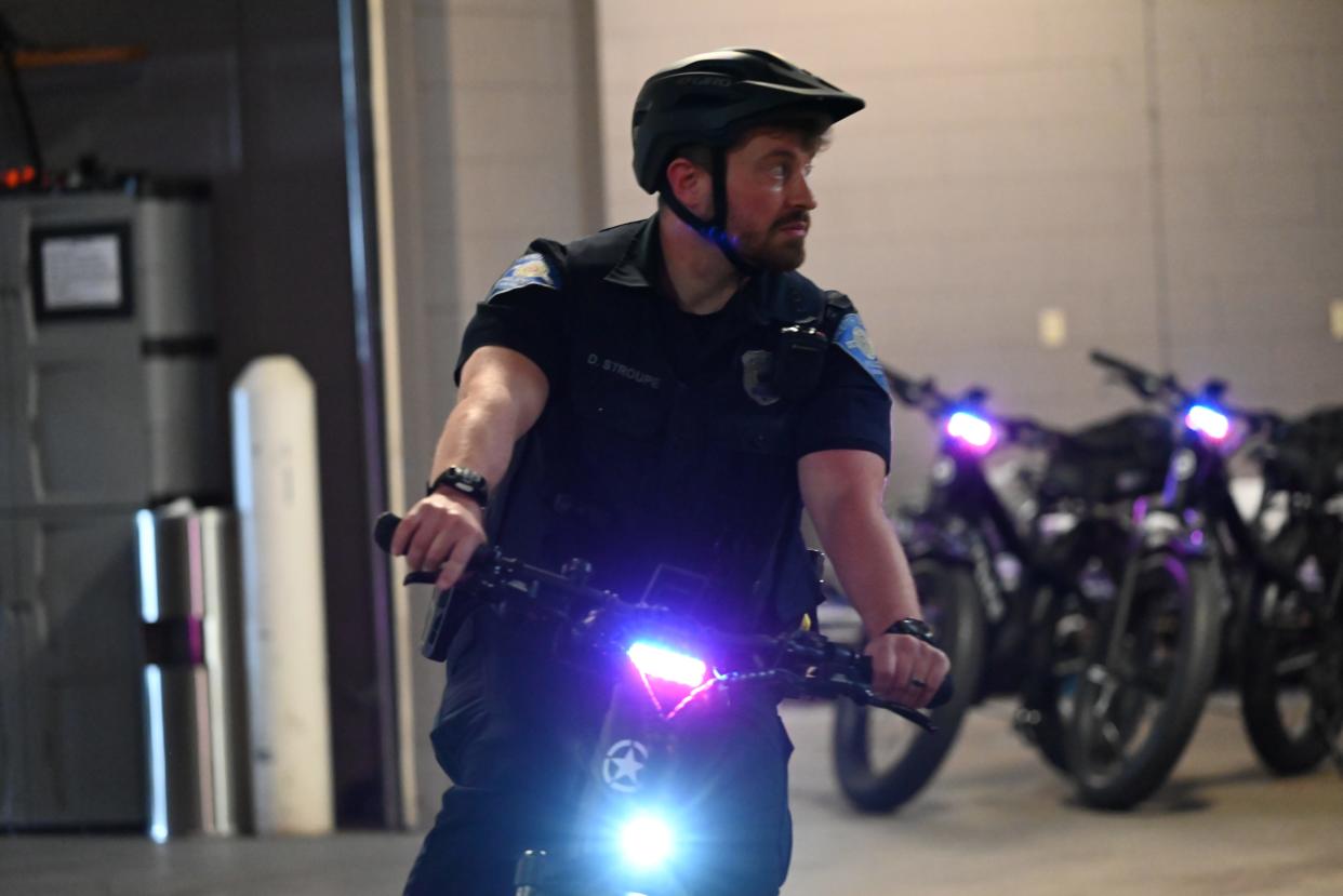 South Bend Police Department Patrolman First Class Dalton Stroupe demonstrates riding a police e-bike on May 9, 2024, in the department's garage at 701 W. Sample St.