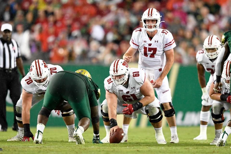 Aug. 30, 2019; Tampa, Florida; Wisconsin Badgers quarterback Jack Coan (17) awaits the ball from offensive lineman Tyler Biadasz (61) during the first half against the South Florida Bulls at Raymond James Stadium. Douglas DeFelice-USA TODAY Sports