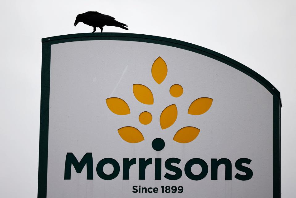 A bird is perched on a Morrisons sign outside its supermarket in Stratford, east London on June 21, 2021. - Shares in British supermarket chain Morrisons surged today after it rejected a £5.5-billion ($7.6-billion, 6.4-billion-euro) takeover approach as too low. (Photo by Tolga Akmen / AFP) (Photo by TOLGA AKMEN/AFP via Getty Images)