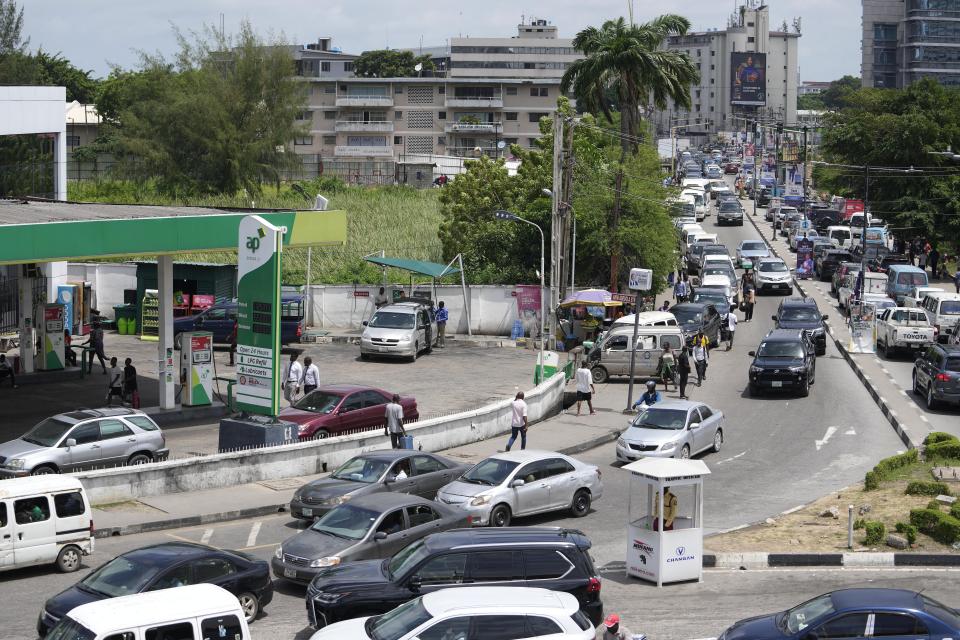 Motorists queue to buy fuel at a petrol station in Lagos, Nigeria, Tuesday, May 30, 2023. Nigerian President Bola Tinubu has scrapped a decadeslong government-funded subsidy that has helped reduce the price of gasoline, leading to long lines at fuel stations Tuesday as drivers scrambled to stock up before costs rise. (AP Photo/Sunday Alamba)