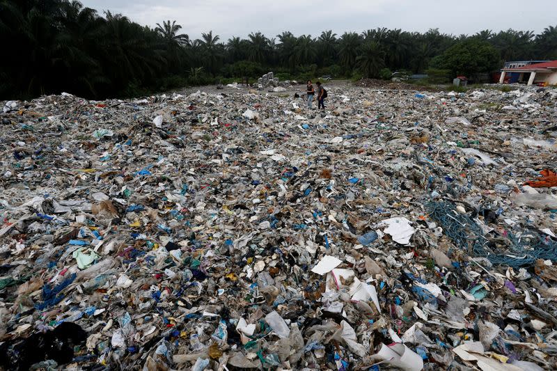 FILE PHOTO: Plastic waste piled outside an illegal recycling factory in Jenjarom, Kuala Langat
