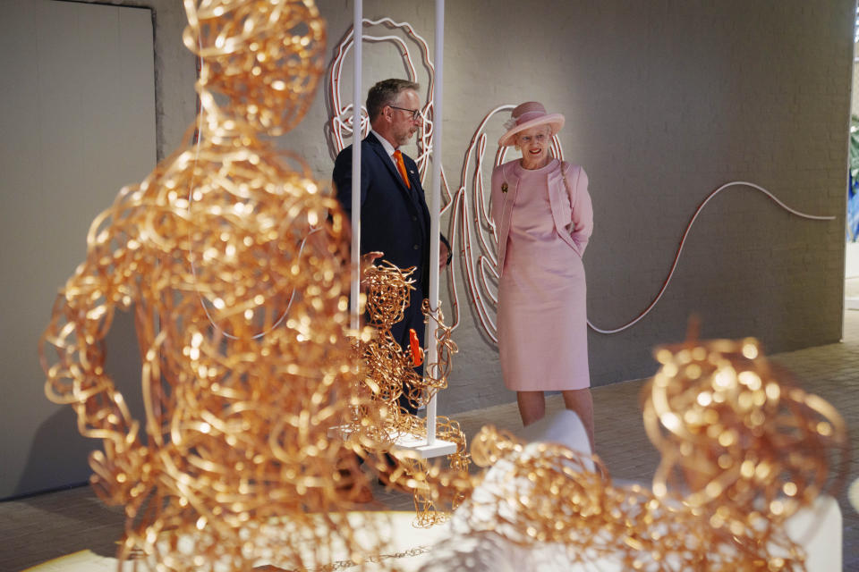 CORRECTS SPELLING OF NAME The Danish Queen Margrethe and museum director Claus Kjeld Jensen walk during the inauguration of the new museum Flugt, in Oksboel, Denmark, Saturday 25 June 2022. Flugt — Refugee Museum of Denmark was created on the site of a camp in Oksboel, a town in southwestern Denmark, that housed up to 100,000 refugees from Germany in the postwar years. Flugt — which means escape in Danish — also tells the story of immigrants from Iran, Lebanon, Hungary, Vietnam and elsewhere who fled their homelands and found shelter in the Scandinavian country. (Bo Amstrup/Ritzau Scanpix via AP)