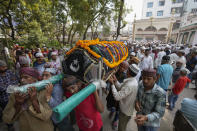 <p>People prepare to cremate the body of a victim of a pedestrian bridge collapse in Morbi town of western state Gujarat, India, Monday, Oct. 31, 2022. The century-old cable suspension bridge collapsed into the river Sunday evening, sending hundreds plunging in the water, officials said. (AP Photo/Ajit Solanki)</p> 