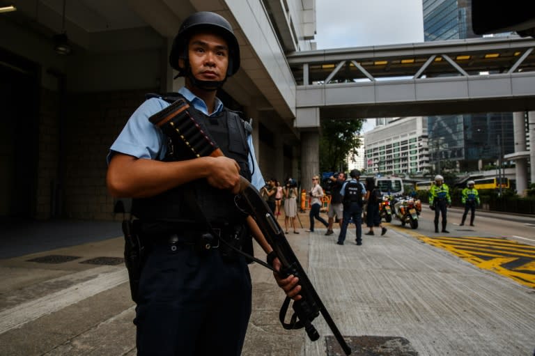 An armed policeman stands guard after the arrival of a prison van (not seen) transporting Rurik Jutting to the High Court in Hong Kong, on October 24, 2016