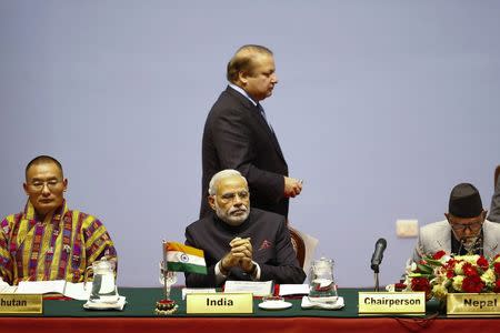 Bhutan's Prime Minister Tshering Tobgay (L), India's Prime Minister Narendra Modi (C), Pakistan's Prime Minister Nawaz Sharif (C, standing) and Nepal's Prime Minister Sushil Koirala attend the opening session of 18th South Asian Association for Regional Cooperation (SAARC) summit in Kathmandu November 26, 2014. REUTERS/Narendra Shrestha/Pool