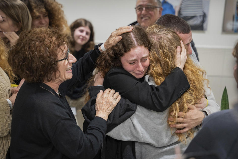 This photo released by the GPO, Meirav Tal, center right, reunites with her family, Tuesday, Nov. 28, 2023, at Sourasky Medical Center, Israel, after being released from Hamas captivity. (GPO/Handout via AP)