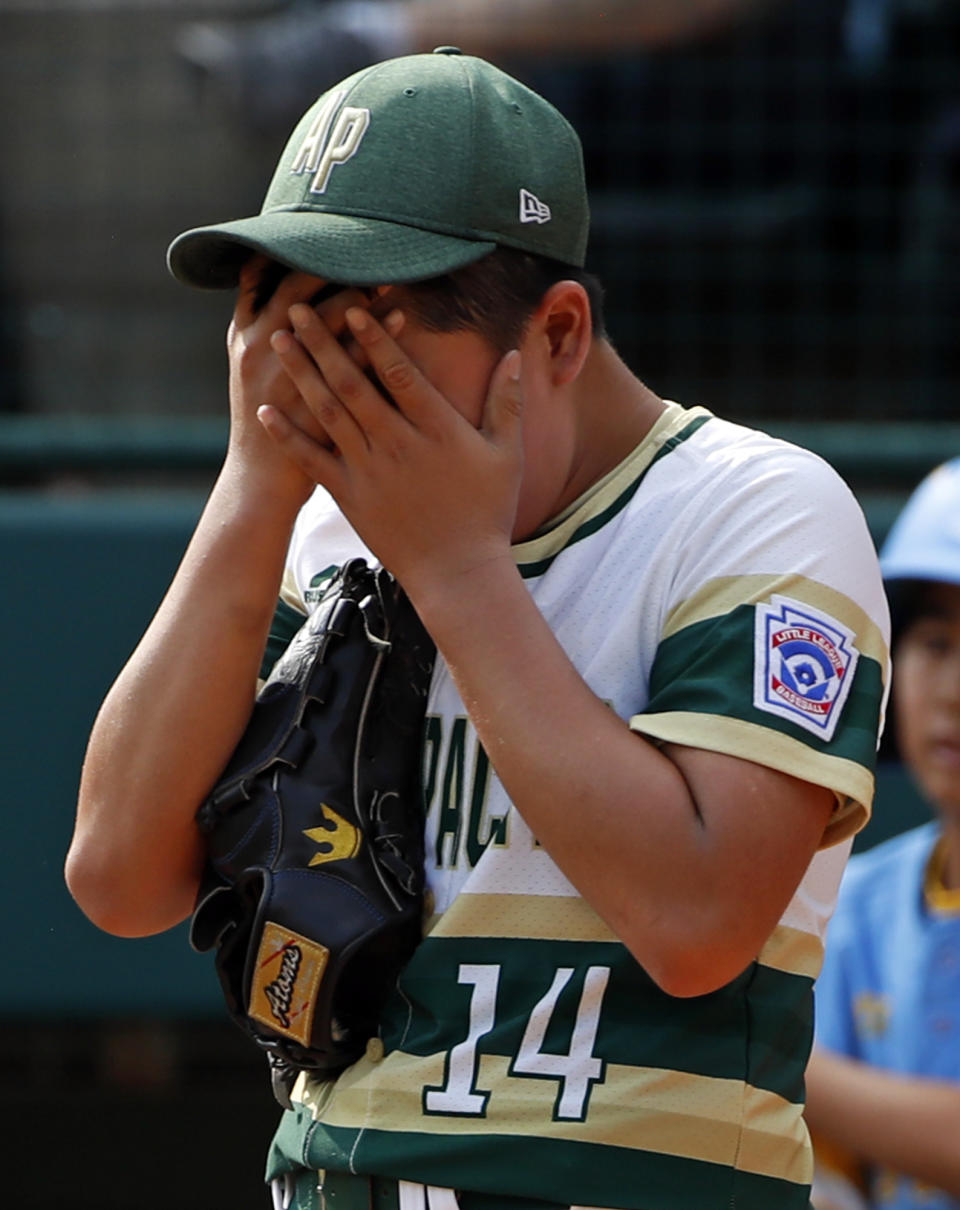 South Korea pitcher Yeong Hyeon Kim collects himself after allowing a run to score from third on a wild pitch in the third inning of the Little League World Series Championship baseball game against Honolulu, Hawaii, in South Williamsport, Pa., Sunday, Aug. 26, 2018. (AP Photo/Gene J. Puskar).