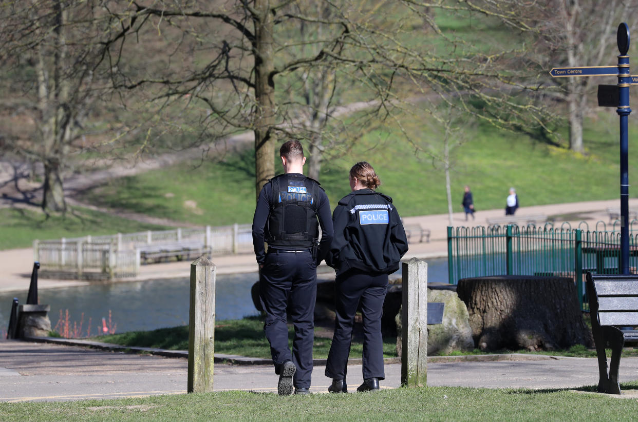 Police officers walk through Mote Park in Maidstone, Kent, the day after Prime Minister Boris Johnson put the UK in lockdown to help curb the spread of the coronavirus. (Photo by Gareth Fuller/PA Images via Getty Images)