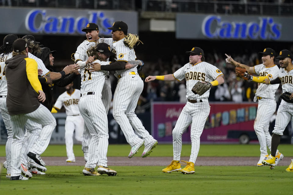 Members of the San Diego Padres celebrate after the Padres defeated the Los Angeles Dodgers 5-3 in Game 4 of a baseball NL Division Series, Saturday, Oct. 15, 2022, in San Diego.(AP Photo/Ashley Landis)