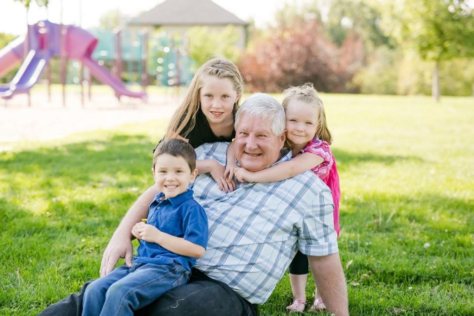 Phage therapy patient Greg Breed with three grandchildren at a playground