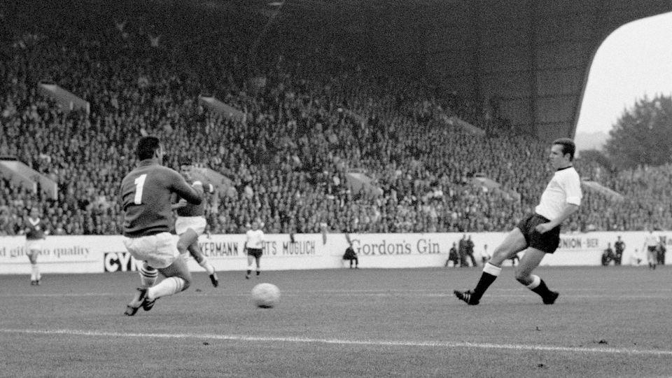 Beckenbauer scores past Switzerland goalkeeper Karl Elsener in 1966. - PA Photos/AP