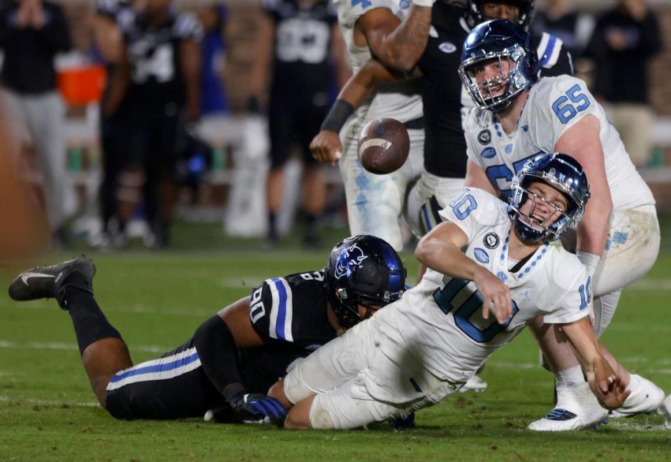 North Carolina Tar Heels quarterback Drake Maye gets off a pass before being brought down by Duke Blue Devils defensive tackle DeWayne Carter during the second half of Saturday’s game at Wallace Wade Stadium in Durham, N.C.