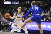 Connecticut's Nika Muhl (10) passes around Creighton's Molly Mogensen (21) in the first half of an NCAA college basketball game, Sunday, Jan. 9, 2022, in Storrs, Conn. (AP Photo/Jessica Hill)