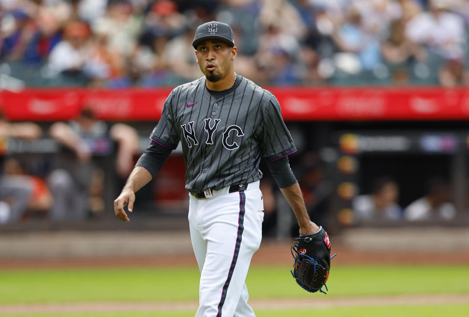 New York Mets' Edwin Díaz goes to the dugout after pitching against the San Francisco Giants during the ninth inning of a baseball game, Saturday, May 25, 2024, in New York. (AP Photo/Noah K. Murray)