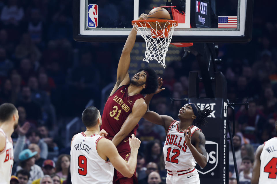 Cleveland Cavaliers center Jarrett Allen (31) dunks against Chicago Bulls guard Ayo Dosunmu (12) and center Nikola Vucevic (9) during the first half of an NBA basketball game, Monday, Jan. 2, 2023, in Cleveland. (AP Photo/Ron Schwane)