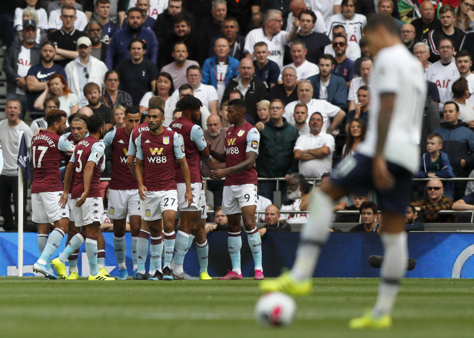 Aston Villa's John McGinn celebrates with teammates after scoring his side's opening goal during the English Premier League soccer match between Tottenham Hotspur and Aston Villa at the Tottenham Hotspur stadium in London, Saturday, Aug. 10, 2019. (AP Photo/Frank Augstein)