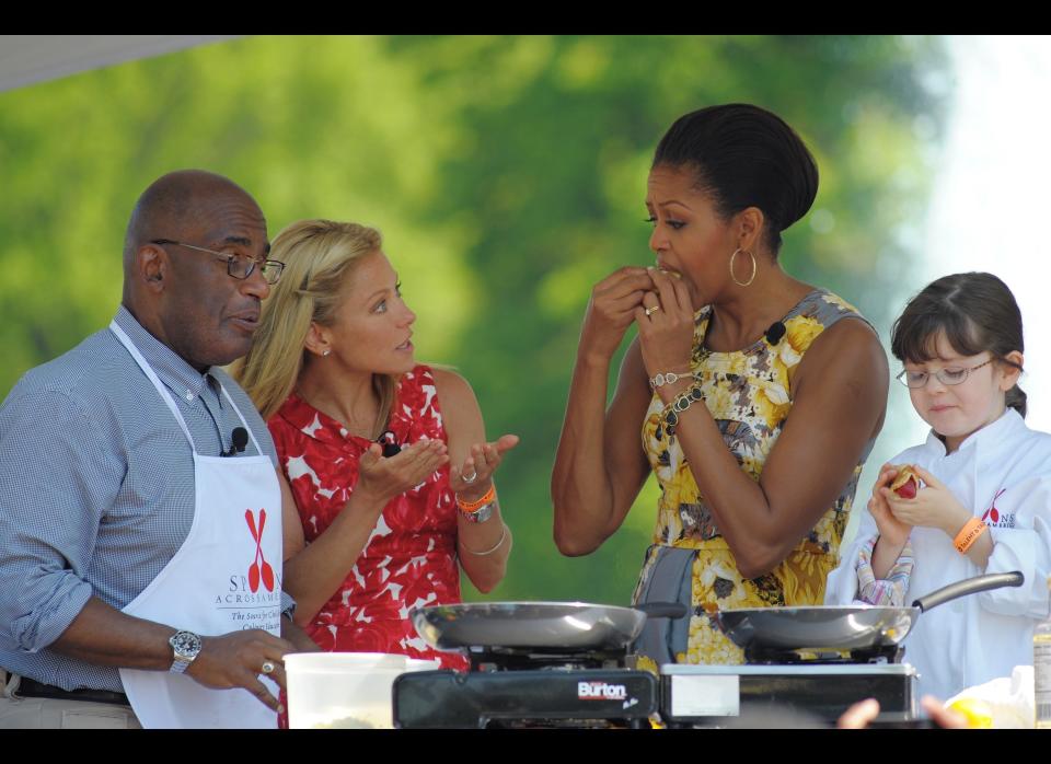 First Lady Michelle Obama samples a crepe as TV personalities Al Roker and Kelly Rippa looks on during an health eating event at the annual Easter egg roll April 25, 2011 on the South Lawn of the White House in Washington, DC. AFP PHOTO/Mandel NGAN (Photo credit should read MANDEL NGAN/AFP/Getty Images)