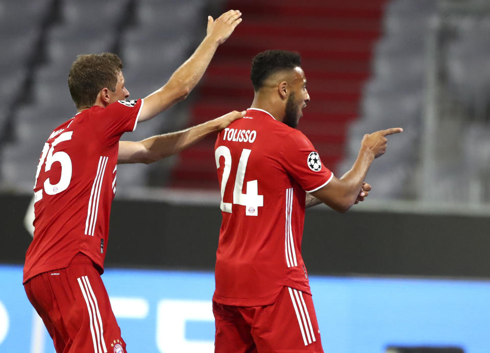 Bayern's Corentin Tolisso, right, celebrates after scoring his team's third goal during the Champions League round of 16 second leg soccer match between Bayern Munich and Chelsea at Allianz Arena in Munich, Germany, Saturday, Aug. 8, 2020. (AP Photo/Matthias Schrader)