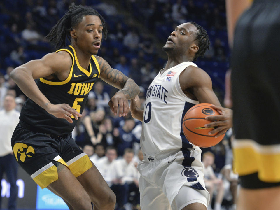 Penn State's Kanye Clary (0) pulls up in front of Iowa's Dasonte Bowen (5) during the first half of an NCAA college basketball game Thursday, Feb. 8, 2024, in State College, Pa. (AP Photo/Gary M. Baranec)