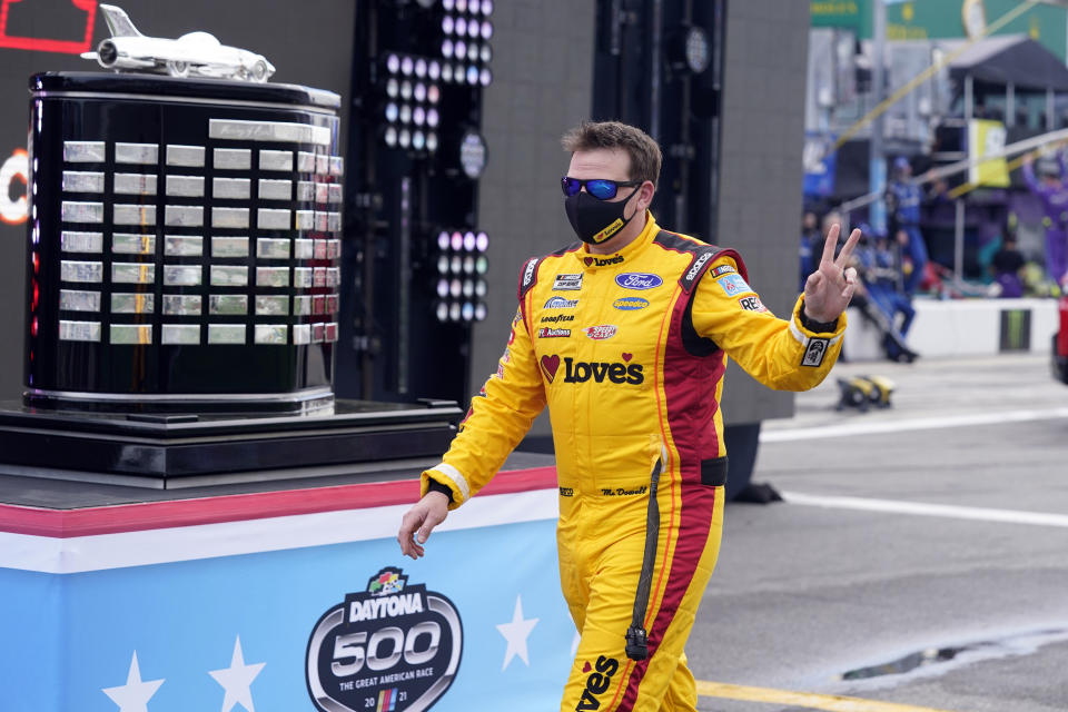 Michael McDowell walks by the championship trophy before the NASCAR Daytona 500 auto race at Daytona International Speedway, Sunday, Feb. 14, 2021, in Daytona Beach, Fla. Michael McDowell followed his Daytona 500 victory with a pair of top-10 finishes. That's three in three races, one shy of his total from all of 2020. Perhaps his Front Row Motorsports team really has turned the corner. (AP Photo/John Raoux)