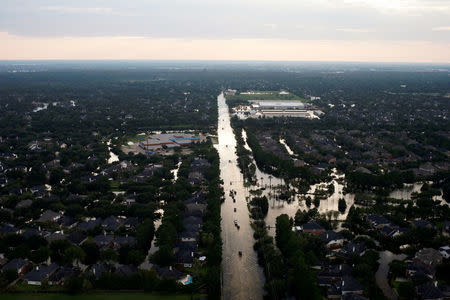 FILE PHOTO: Cars pass through flood waters caused by Tropical Storm Harvey along Tanner Road in West Houston, Texas, U.S., August 30, 2017. REUTERS/Adrees Latif/File Photo