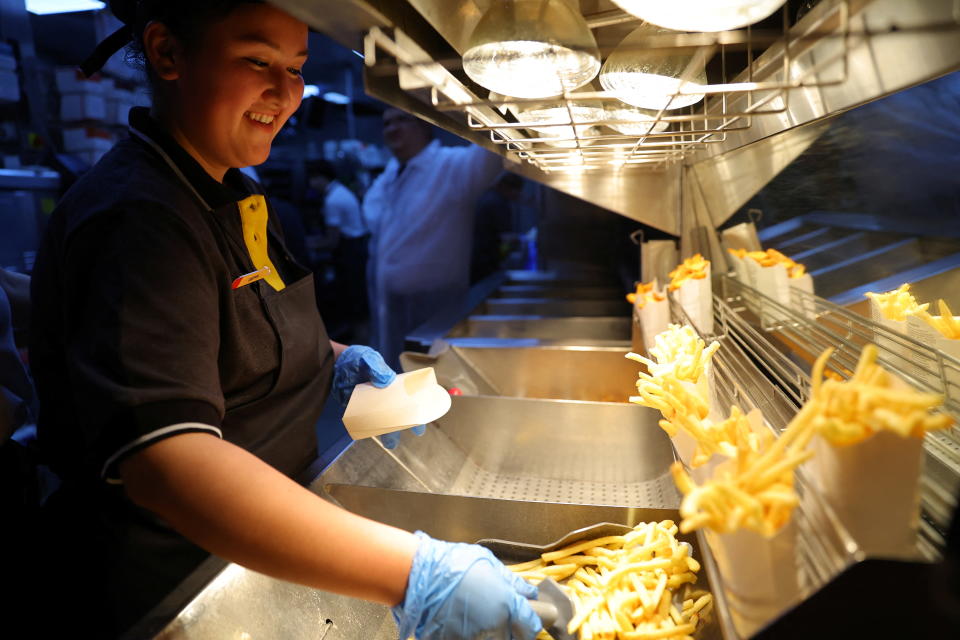 An employee cooks fries at the new restaurant 