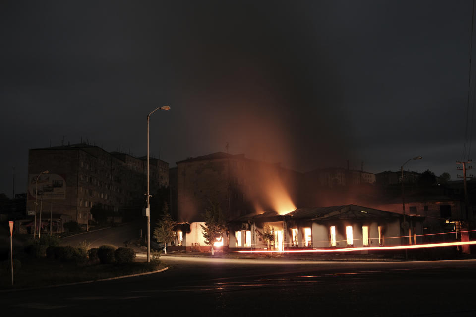 A building of a residential area burns after night shelling by Azerbaijan's artillery during a military conflict in self-proclaimed Republic of Nagorno-Karabakh, Stepanakert, Azerbaijan, early Sunday, Oct. 4, 2020. Armenian officials on Sunday accused Azerbaijan of carrying out strikes on Stepanakert. Azerbaijan's Defense Ministry said Armenian forces were attacking the towns of Terter and Horadiz from Stepanakert. (Areg Balayan/ArmGov PAN Photo via AP)