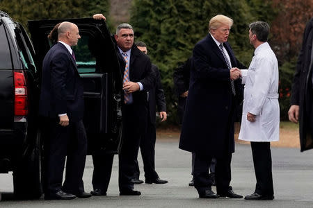 U.S. President Donald Trump shakes hands with Dr. Ronny Jackson after his annual physical exam at Walter Reed National Military Medical Center in Bethesda, Maryland, U.S., January 12, 2018. REUTERS/Yuri Gripas