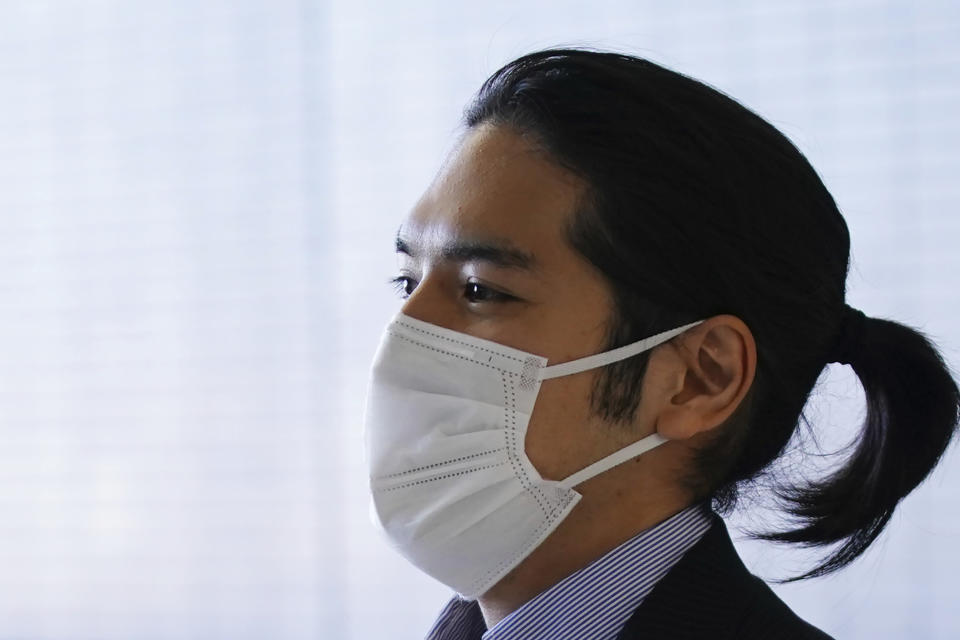 Kei Komuro, fiance of Japan's Princess Mako, arrives at Narita international airport in Narita, near Tokyo, Monday, Sept. 27, 2021 upon returning to Japan from the United States. (AP Photo/Eugene Hoshiko)