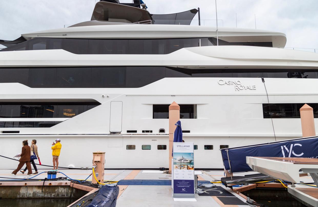 People walk by the Casino Royale yacht at the Palm Beach International Boat Show on Friday.