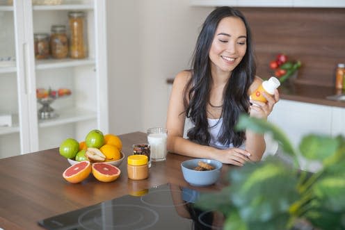 <span class="caption">Vitamin supplements may help you avoid deficiencies. </span> <span class="attribution"><a class="link " href="https://www.shutterstock.com/image-photo/smiling-girl-bottle-vitamins-sitting-kitchen-1572303289" rel="nofollow noopener" target="_blank" data-ylk="slk:YAKOBCHUK VIACHESLAV/ Shutterstock;elm:context_link;itc:0;sec:content-canvas">YAKOBCHUK VIACHESLAV/ Shutterstock</a></span>