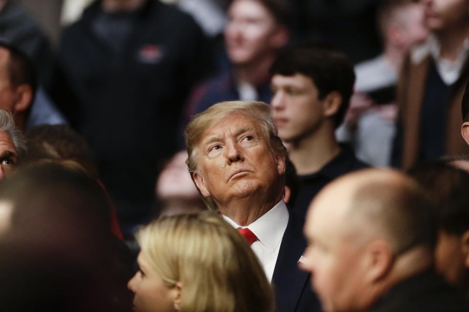 President Donald Trump watches a replay of a lightweight mixed martial arts bout between Kevin Lee and Gregor Gillespie at UFC 244, Saturday, Nov. 2, 2019, in New York. Lee stopped Gillespie in the first round. (AP Photo/Frank Franklin II)