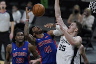 Detroit Pistons forward Saddiq Bey (41) is fouled by San Antonio Spurs center Jakob Poeltl (25) during the second half of an NBA basketball game in San Antonio, Thursday, April 22, 2021. (AP Photo/Eric Gay)