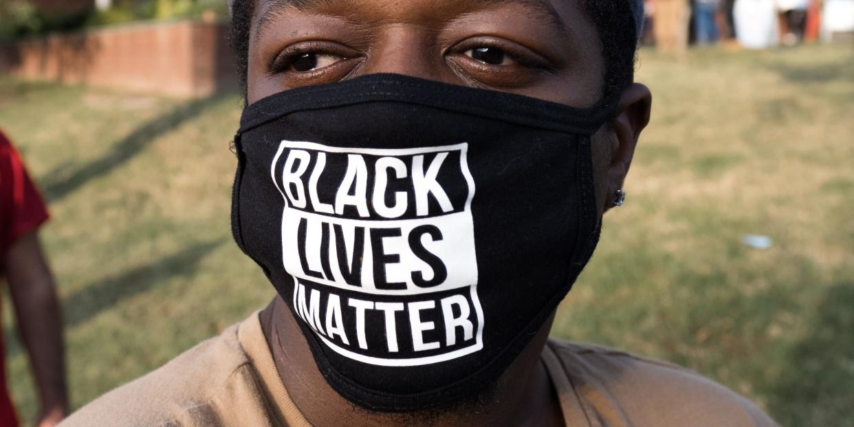 DURHAM, NC - OCTOBER 15: Bryce Hill stands in line to vote while wearing his "Black Lives Matter" mask at the Durham County Library - South Regional Library on the first day of early voting in Durham, North Carolina on October 15, 2020. (Photo by Cornell Watson for the Washington Post)