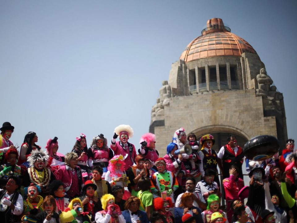 Clowns take part in the 22nd Latin American clown convention at Revolucion monument in Mexico City (REUTERS)