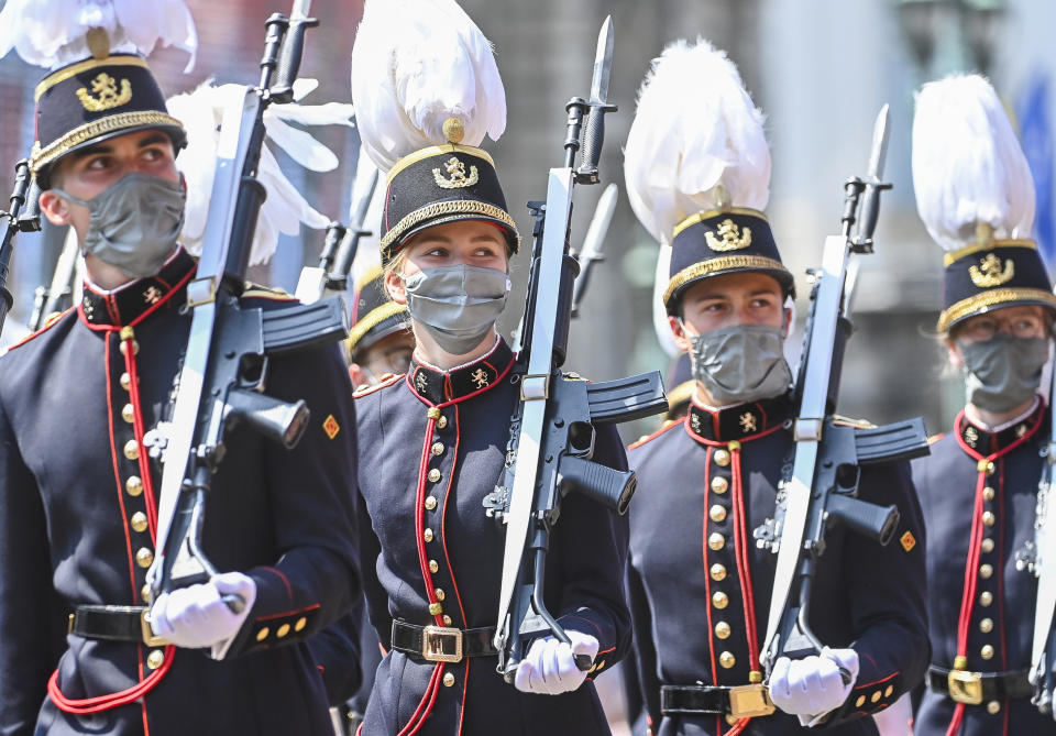 Belgium's Crown Princess Elisabeth, second left, marches with cadets of the military school past the Royal tribune during the National Day parade in Brussels, Wednesday, July 21, 2021. Belgium celebrates its National Day on Wednesday in a scaled down version due to coronavirus, COVID-19 measures. (Laurie Dieffembacq, Pool Photo via AP)