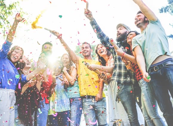 Group of people throwing confetti at a party